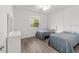 Bright bedroom with twin beds, wood floors and a sunny window at 7908 Sw 89Th Cir, Ocala, FL 34481