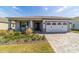 Well-manicured lawn and landscaping highlight this charming single-story home with a brick-paved driveway at 7908 Sw 89Th Cir, Ocala, FL 34481