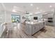Open-concept kitchen with a large island, stainless steel appliances, gray cabinetry, and abundant natural light at 7908 Sw 89Th Cir, Ocala, FL 34481