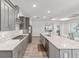 Modern kitchen with gray cabinets, stainless appliances, and a patterned backsplash at 7908 Sw 89Th Cir, Ocala, FL 34481
