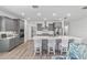 Modern gray kitchen with a spacious island, stainless steel appliances, and stylish backsplash at 7908 Sw 89Th Cir, Ocala, FL 34481
