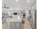 Modern kitchen with a large granite island, stainless steel appliances, and open flow to the living room at 7908 Sw 89Th Cir, Ocala, FL 34481