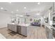 Open concept kitchen with island and adjacent living area filled with natural light at 7908 Sw 89Th Cir, Ocala, FL 34481