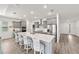 Spacious kitchen featuring gray cabinets, a large island with seating, and modern stainless steel appliances at 7908 Sw 89Th Cir, Ocala, FL 34481