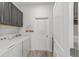 Functional laundry room with gray cabinets and modern appliances at 7908 Sw 89Th Cir, Ocala, FL 34481