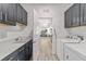 Functional laundry room with gray cabinets and modern appliances at 7908 Sw 89Th Cir, Ocala, FL 34481