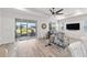 Bright open-concept living room with a ceiling fan, recessed lighting, access to the lanai, and stylish decor at 7908 Sw 89Th Cir, Ocala, FL 34481
