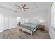 Bright main bedroom with decorative accent wall, tray ceiling, and ensuite access at 7908 Sw 89Th Cir, Ocala, FL 34481