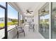Covered patio area features comfortable seating, ceiling fan, and screened windows showcasing backyard views at 7908 Sw 89Th Cir, Ocala, FL 34481