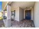 Inviting front porch featuring a gray brick floor, chairs and direct access to the front door at 7908 Sw 89Th Cir, Ocala, FL 34481