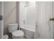 Cozy bathroom with a toilet and bathtub combo with white tile at 8210 Sw 57Th Ct, Ocala, FL 34476