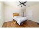 Comfortable bedroom featuring wood floors, ceiling fan, and neutral walls at 8342 Sw 82Nd Loop, Ocala, FL 34481