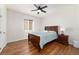 Bedroom with wood look flooring, light walls, and a window letting in natural light at 8342 Sw 82Nd Loop, Ocala, FL 34481