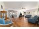 Bright living room features hardwood floors, ceiling fan, and sliding doors to lanai at 8342 Sw 82Nd Loop, Ocala, FL 34481