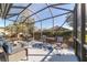 Relaxing screened patio with comfortable outdoor seating and view of the backyard at 8342 Sw 82Nd Loop, Ocala, FL 34481