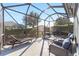 Inviting screened patio with lounge chair, outdoor furniture, and pleasant backyard view at 8342 Sw 82Nd Loop, Ocala, FL 34481