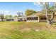 Backyard featuring a green lawn, patio with seating, and a view of the back of the home at 8350 Sw 93Rd Ln # C, Ocala, FL 34481