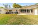 Backyard features a patio with seating and a view of the home's exterior at 8350 Sw 93Rd Ln # C, Ocala, FL 34481