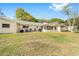 The backyard features a green lawn and patio seating along the back of the home at 8350 Sw 93Rd Ln # C, Ocala, FL 34481