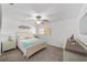 Cozy bedroom features a ceiling fan, large window, and comfortable furnishings, creating a serene retreat at 8350 Sw 93Rd Ln # C, Ocala, FL 34481