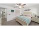 Bright bedroom featuring neutral colors, a ceiling fan, and ample closet space, offering comfort and functionality at 8350 Sw 93Rd Ln # C, Ocala, FL 34481