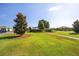 Beautifully landscaped community green space with walking path, pergola and mature trees under a clear blue sky at 8350 Sw 93Rd Ln # C, Ocala, FL 34481