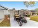 Exterior view of the home with a golf cart parked in front of the garage at 8350 Sw 93Rd Ln # C, Ocala, FL 34481