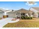 Charming single-story home with a covered porch, attached garage, and manicured front yard at 8350 Sw 93Rd Ln # C, Ocala, FL 34481