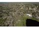 An aerial view showcasing an estate property with private lake frontage, a swimming pool, and a sprawling backyard at 8380 Se 7Th Avenue Rd, Ocala, FL 34480
