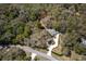 A lush, wooded lot with a home featuring circular driveway with landscaping and ample privacy from surrounding trees at 8380 Se 7Th Avenue Rd, Ocala, FL 34480