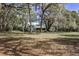 Large backyard with mature trees providing shade, surrounded by a peaceful setting at 8380 Se 7Th Avenue Rd, Ocala, FL 34480