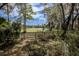 Spacious backyard with view of a tranquil lake and mature trees draped with Spanish moss at 8380 Se 7Th Avenue Rd, Ocala, FL 34480