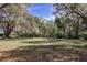 Expansive backyard featuring mature trees offering plenty of space for outdoor activities at 8380 Se 7Th Avenue Rd, Ocala, FL 34480