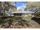 Expansive backyard with mature trees and landscaping surrounding the home at 8380 Se 7Th Avenue Rd, Ocala, FL 34480