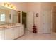 Traditional bathroom featuring tiled floors, double doors, and a vanity with a sink at 8380 Se 7Th Avenue Rd, Ocala, FL 34480