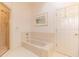 Bright bathroom with a tiled shower, separate tub, and neutral color palette at 8380 Se 7Th Avenue Rd, Ocala, FL 34480