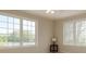 Light-filled bedroom featuring large windows with pleasant views of the surrounding property at 8380 Se 7Th Avenue Rd, Ocala, FL 34480