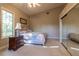 Cozy bedroom features a neutral color palette, plush carpeting and vaulted ceiling at 8380 Se 7Th Avenue Rd, Ocala, FL 34480