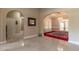 Spacious foyer with marble flooring, arched doorways, and a view into a dining room with elegant chandelier lighting at 8380 Se 7Th Avenue Rd, Ocala, FL 34480