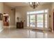 Elegant foyer with marble floors, a chandelier, and double doors leading to an outdoor patio, creating a grand entrance at 8380 Se 7Th Avenue Rd, Ocala, FL 34480