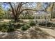 Beautiful white gazebo nestled in a tranquil garden setting with lush greenery and mature trees at 8380 Se 7Th Avenue Rd, Ocala, FL 34480