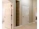 Hallway featuring doorways to other rooms and built-in shelving with glass shelves at 8380 Se 7Th Avenue Rd, Ocala, FL 34480
