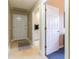 Entryway or hallway with tile flooring and view into laundry area at 8380 Se 7Th Avenue Rd, Ocala, FL 34480