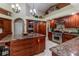 Spacious kitchen boasts wooden cabinets, granite counters, large island, stainless appliances, and ample storage at 8380 Se 7Th Avenue Rd, Ocala, FL 34480