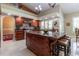 Bright kitchen showcasing granite island, wooden cabinets, tiled backsplash, and stainless steel oven at 8380 Se 7Th Avenue Rd, Ocala, FL 34480