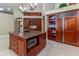 Open kitchen featuring granite island, wooden cabinets, built-in oven, and shelving with integrated fridge at 8380 Se 7Th Avenue Rd, Ocala, FL 34480