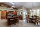 A spacious kitchen with wooden cabinets, granite countertops, a central island with bar seating, and modern appliances at 8380 Se 7Th Avenue Rd, Ocala, FL 34480