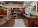 Bright kitchen with wooden cabinets, granite counters, and modern appliances provides lots of counterspace at 8380 Se 7Th Avenue Rd, Ocala, FL 34480