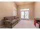 Bright living room featuring a comfortable sofa, a vaulted ceiling, and glass doors to the outside at 8380 Se 7Th Avenue Rd, Ocala, FL 34480