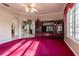 Spacious living room with large window, archways, and custom built-in cabinetry for seamless storage at 8380 Se 7Th Avenue Rd, Ocala, FL 34480